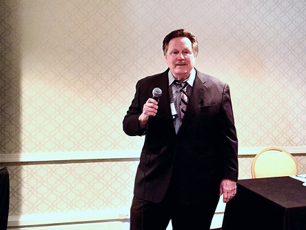 dr. nay with a microphone, presenting to a group of people dr. nay with a microphone, presenting to a group of people