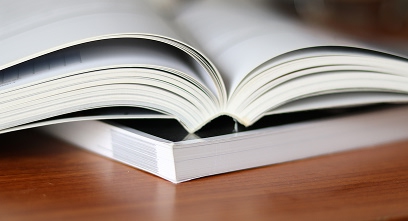 stacked books on a wooden table stacked books on a wooden table